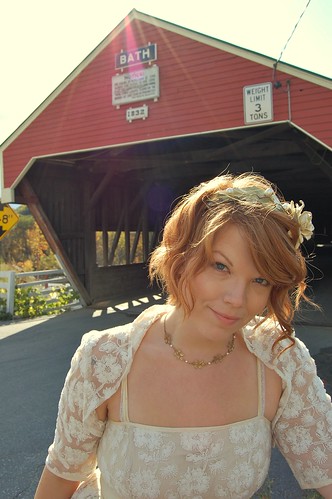 bride in front of covered bridge