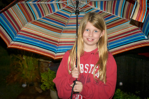 Nora getting practice with an umbrella.  Not too much cause to own one here but occasionally they come in handy. • <a style="font-size:0.8em;" href="http://www.flickr.com/photos/96277117@N00/32969506130/" target="_blank">View on Flickr</a>