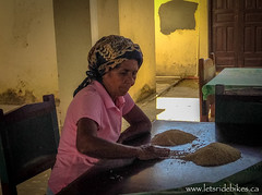 Hilda, sorting through the rice for tonight's meal.
