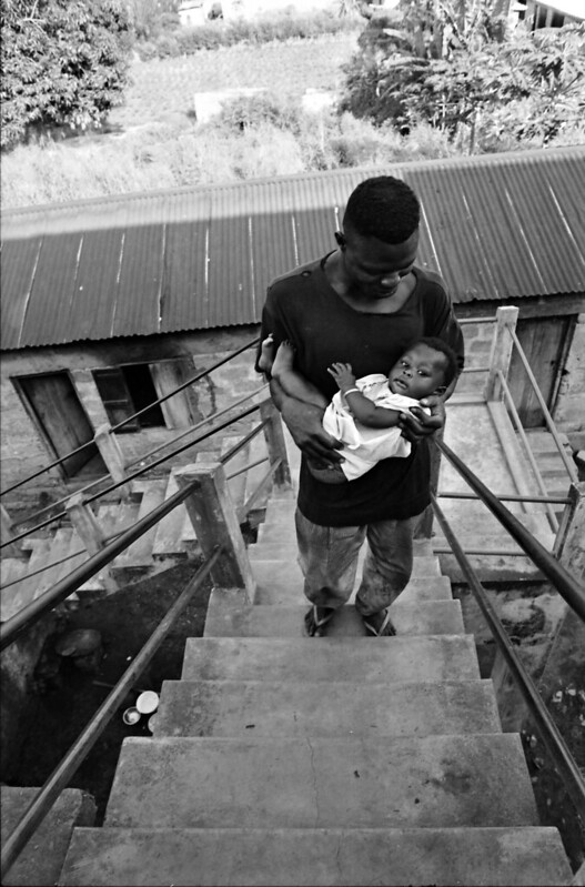 Togo West Africa Togolese African Father and Daughter Village close to Palimé formerly known as Kpalimé is a city in Plateaux Region Togo near the Ghanaian border B&W 23 April 1999 084<br/>© <a href="https://flickr.com/people/41087279@N00" target="_blank" rel="nofollow">41087279@N00</a> (<a href="https://flickr.com/photo.gne?id=13924954371" target="_blank" rel="nofollow">Flickr</a>)