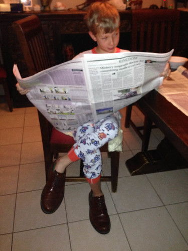 Kai reads the paper every morning.  Only occasionally does he also put on Dad's shoes. • <a style="font-size:0.8em;" href="http://www.flickr.com/photos/96277117@N00/12333639734/" target="_blank">View on Flickr</a>