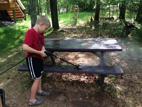 Kai powerwashing the picnic table.  Perfect job for him. • <a style="font-size:0.8em;" href="http://www.flickr.com/photos/96277117@N00/14791145094/" target="_blank">View on Flickr</a>