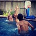 Noel and his friends are playing a little pool basketball.