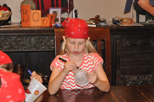 Nora decorates her pirate cup • <a style="font-size:0.8em;" href="http://www.flickr.com/photos/96277117@N00/15382481168/" target="_blank">View on Flickr</a>